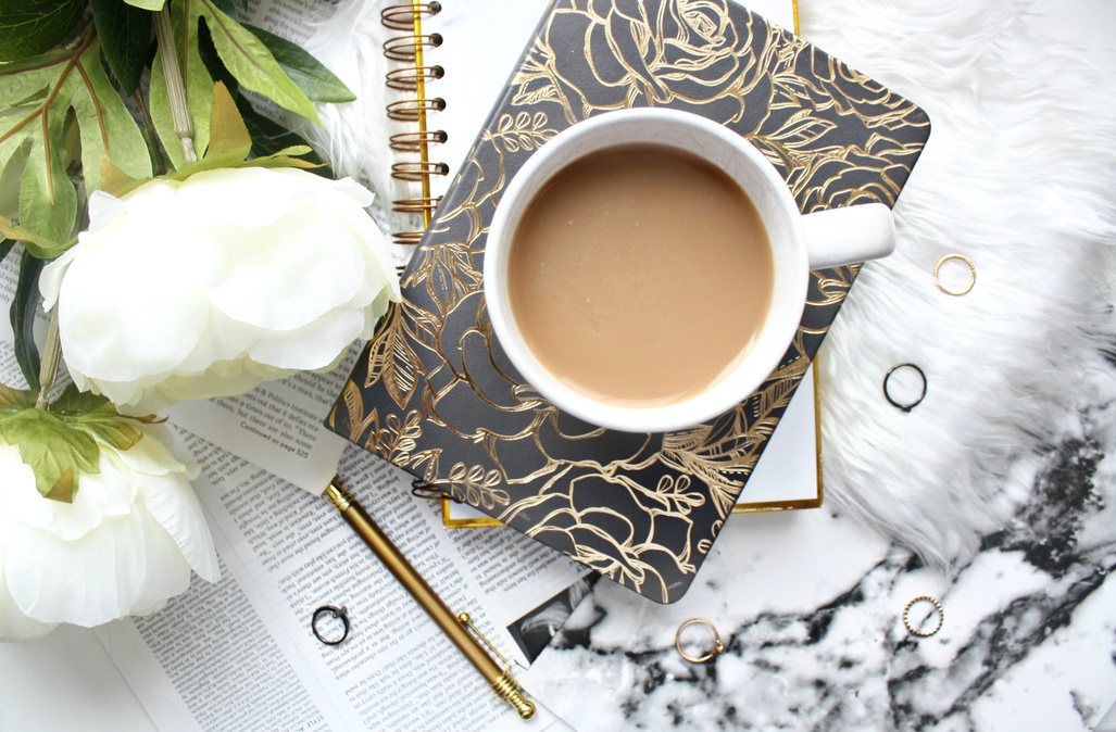 Top View of a Coffee Cup on a Notebook